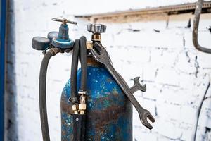 Old gas cylinders for welding and cutting. Rusty propane and oxygen tanks. photo