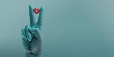 Blood Donation Concept. Help, Care, Love, Support. Hand Gesture with Medical Glove Holding a Red Heart and Cross Sign photo