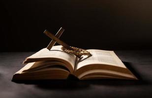 Spirituality, Religion and Hope Concept. Holy Bible and Cross on Desk. Symbol of Humility, Supplication,Believe and Faith for Christian People photo