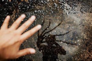 Conceptual Photo. Hello Stranger Concept. Photogrpaher taking Self Portrait by Shadow on the Ground. Strange Creepy Hand Reflects on the Floor. Top View photo