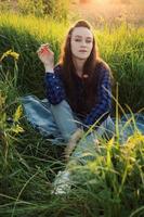 Portrait of a beautiful young woman on meadow photo