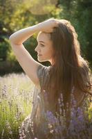 The girl sit in the middle of a lavender field photo