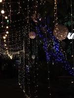 Twinkling ball light on tree in midnight photo