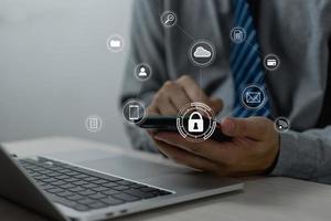 Businessman working with smartphone in hands. Cybersecurity hologram with glowing lock icons on the virtual screen.Business technology internet and networking concept photo