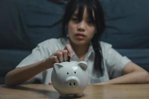 child asian finance economic investment wealth pig currency money business banking, cash success saving girl holding coin piggy bank. photo