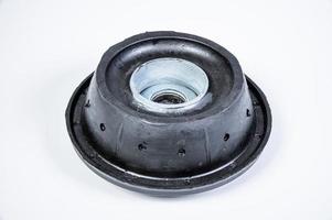 New thrust bearing of front suspension strut of a car on a gray background. The concept of new spare parts and replacement parts in service centers photo