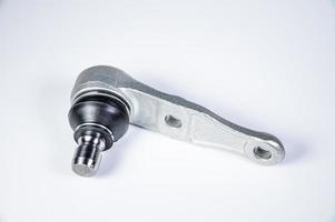 New spare parts spherical ball joints of a suspension bracket of a car on a gray background photo