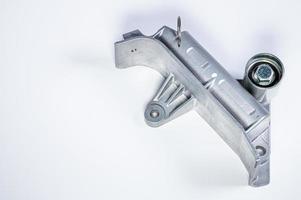 Tension mechanism roller of a timing belt of an internal combustion engine on a gray background. The concept of new spare parts and maintenance of vehicles photo