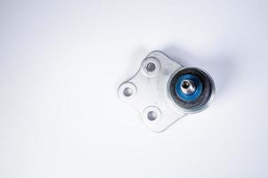 New spare parts spherical ball joints of a suspension bracket of a car on a gray background photo