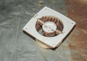 Close-up of a very dirty kitchen exhaust fan. Fan before preventive cleaning and washing. Dirty details photo