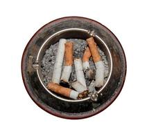 Ashtray full of cigarettes close-up. Isolated over white background. Anti-smoking concept. photo