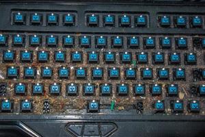 Very dirty keyboard. Dog hair, breadcrumbs and dust accumulated under the keys. Mechanical keyboard switches without buttons photo