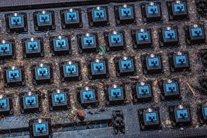 Very dirty keyboard. Dog hair, breadcrumbs and dust accumulated under the keys. Mechanical keyboard switches without buttons photo