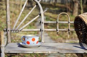 Rustic still life with a cup of tea and straw hat photo