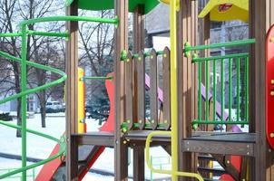 Fragment of a playground made of plastic and wood, painted in different colors photo