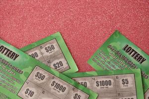 Close up view of green lottery scratch cards. Many used fake instant lottery tickets with gambling results. Gambling addiction photo