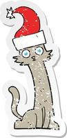 pegatina retro angustiada de un gato de dibujos animados con sombrero de navidad vector