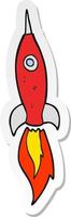 sticker of a cartoon rocket vector