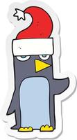 sticker of a cartoon penguin in christmas hat vector