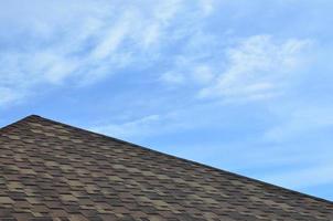 The roof covered with a modern flat bituminous waterproof coating under a blue sky photo