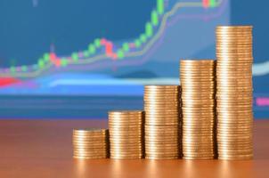 Golden coin stacks arranged as a graph. Increasing columns of coins photo