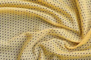 Yellow sport jersey clothing fabric texture and background with many folds photo