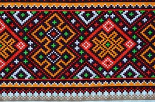 Traditional Ukrainian folk art knitted embroidery pattern on textile fabric photo