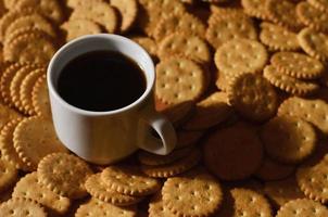 Small coffee cup and salted cracker photo