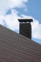 The roof covered with a modern flat bituminous waterproof coating under a blue sky photo