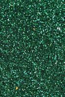 Colorful defocused emerald green background with glittering and sparkling spots