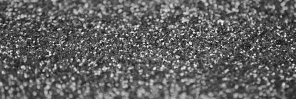 Silver decorative sequins. Background image with shiny bokeh lights from small elements photo