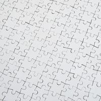 Close up texture of a white jigsaw puzzle in assembled condition. Top view. Many components of a large whole mosaic are united photo