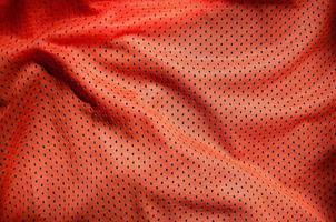 Close up of red polyester nylon sportswear shorts to created a textured background photo