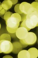 Bokeh effect golden yellow defocused light background. Christmas Lights Concept photo