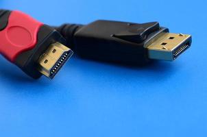 Audio video HDMI computer cable plug and 20-pin male DisplayPort gold plated connector for a flawless connection on a blue background photo