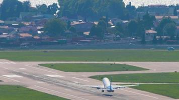 SOCHI, RUSSIA JULY 28, 2022 - Long shot rear view of Boeing 737 Pobeda airline takeoff and climb over the sea at Sochi International Airport. Tourism and travel concept video