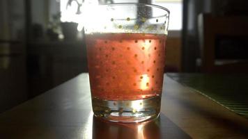 Effervescent tablet in water with bubbles, against influenza, slow motion video