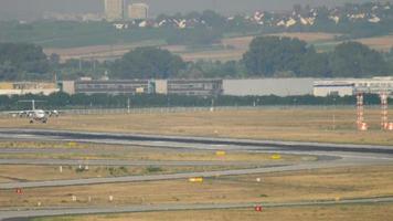 Four engine airplane approaching and landing at afternoon haze. Frankfurt, Germany video