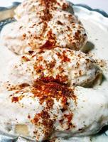 Dahi vada or bhalla is a type of chaat originating from the Indian and popular throughout South Asia. photo