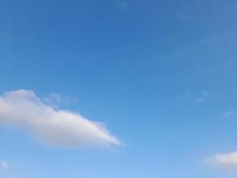 blue sky with puffy clouds background photo