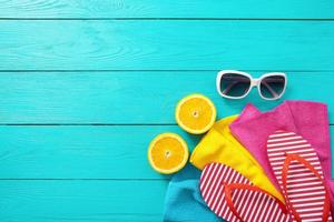 Summer fun. Fruits and accessories on blue wooden background. Top view and copy space photo