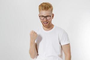 Champion, life winner concept. Young successful entrepreneur with Strong ambitions, passion be number one. Handsome man with redhead, red beard in stylish glasses. White shirt. Copy space. Hairstyle photo