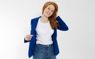 Happy red haired business woman in template blank white t shirt and stylish jacket isolated on gray background. Self career and job consulting knowledge. Young ceo entrepreneur and casual clothes photo