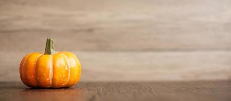 Orange pumpkin on table with copy space for banner background. Happy Halloween day, Hello October, fall autumn season, Festive, party and holiday concept photo