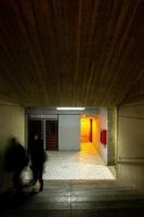 orange light that contrasts with the concrete modern concrete architecture cement building brutalist , stairs of an institution or school, photo