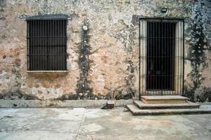 colonial architecture, arches surrounded by vegetation, play of light and shadows inside the space, natural materials photo