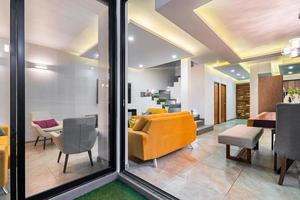 contemporary living and dining room, modern architecture interior, orange armchairs, solid wood table photo