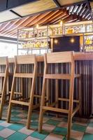 bar stools or benches, with thick pasta floor, at the back vegetation, bar and counter bar. photo