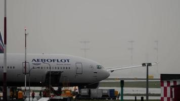 MOSCOW, RUSSIAN FEDERATION JULY 28, 2021 - Luggage is being loaded into a Boeing 777 of Aeroflot. Boeing Aeroflot 777 taxiing to the runway video