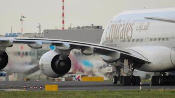 DUSSELDORF, GERMANY JULY 23, 2017 - Double deck Airbus A380 of Emirates Airlines taxiing at Dusseldorf airport. Widebody jet passenger aircraft. Cinematic shot of an airplane on the runway video